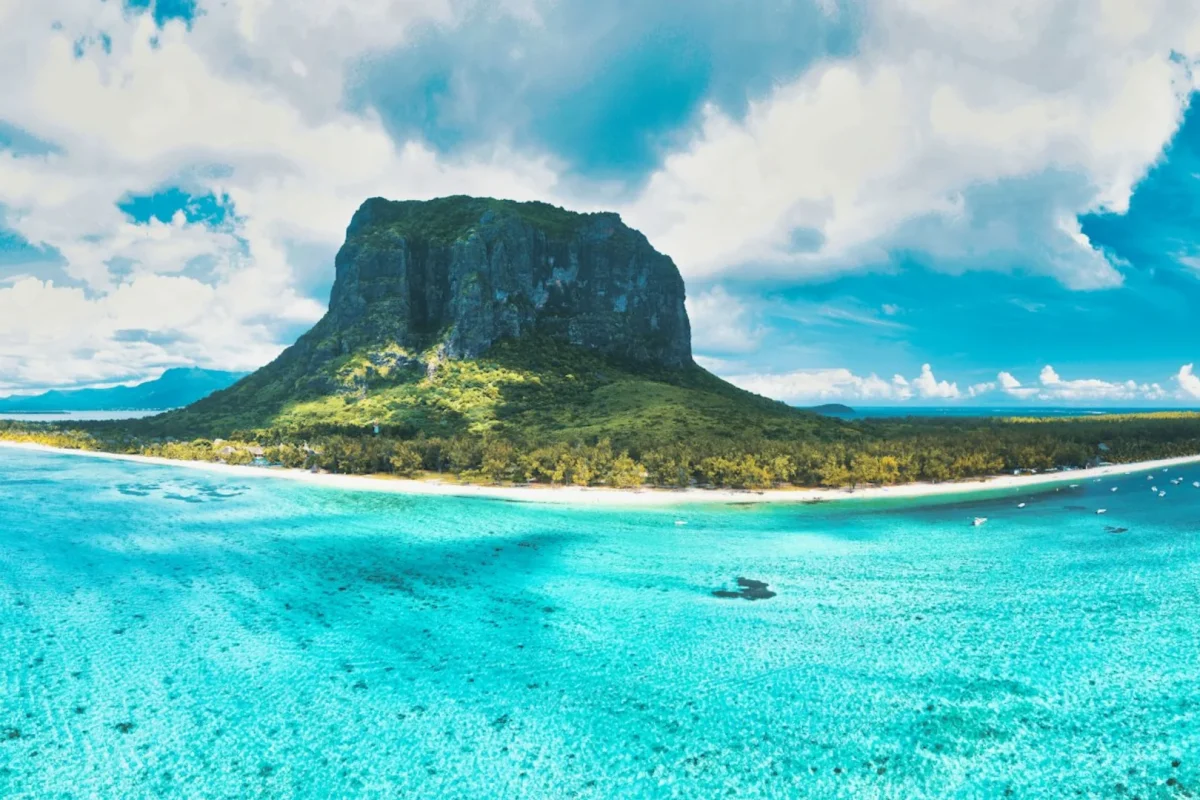 The white sand and calm lagoon of Le Morne beach beneath the mountain