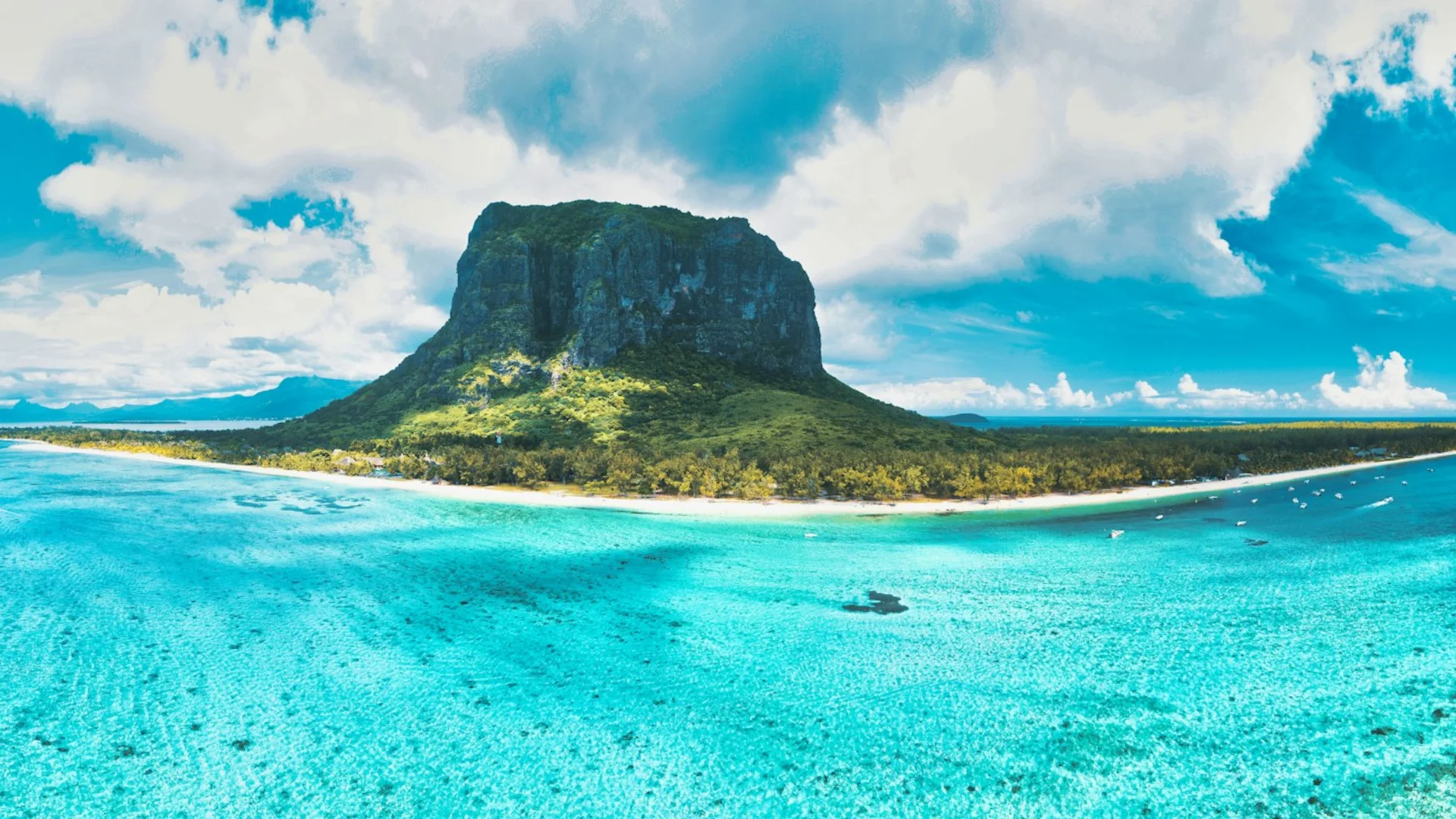 The white sand and turquoise lagoon of Le Morne beach beneath the mountain