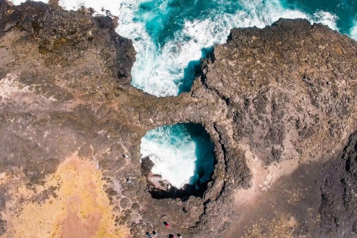 The natural rock bridge of Pont Naturel arching over a sea cave