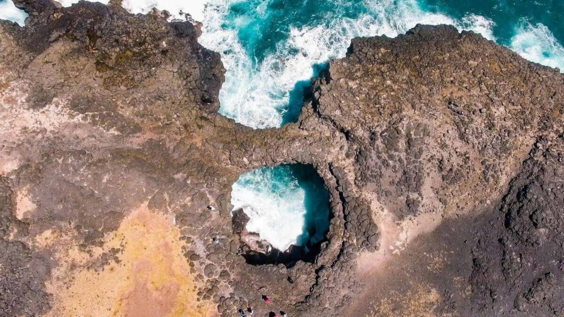 The natural rock bridge of Pont Naturel arching over a sea cave