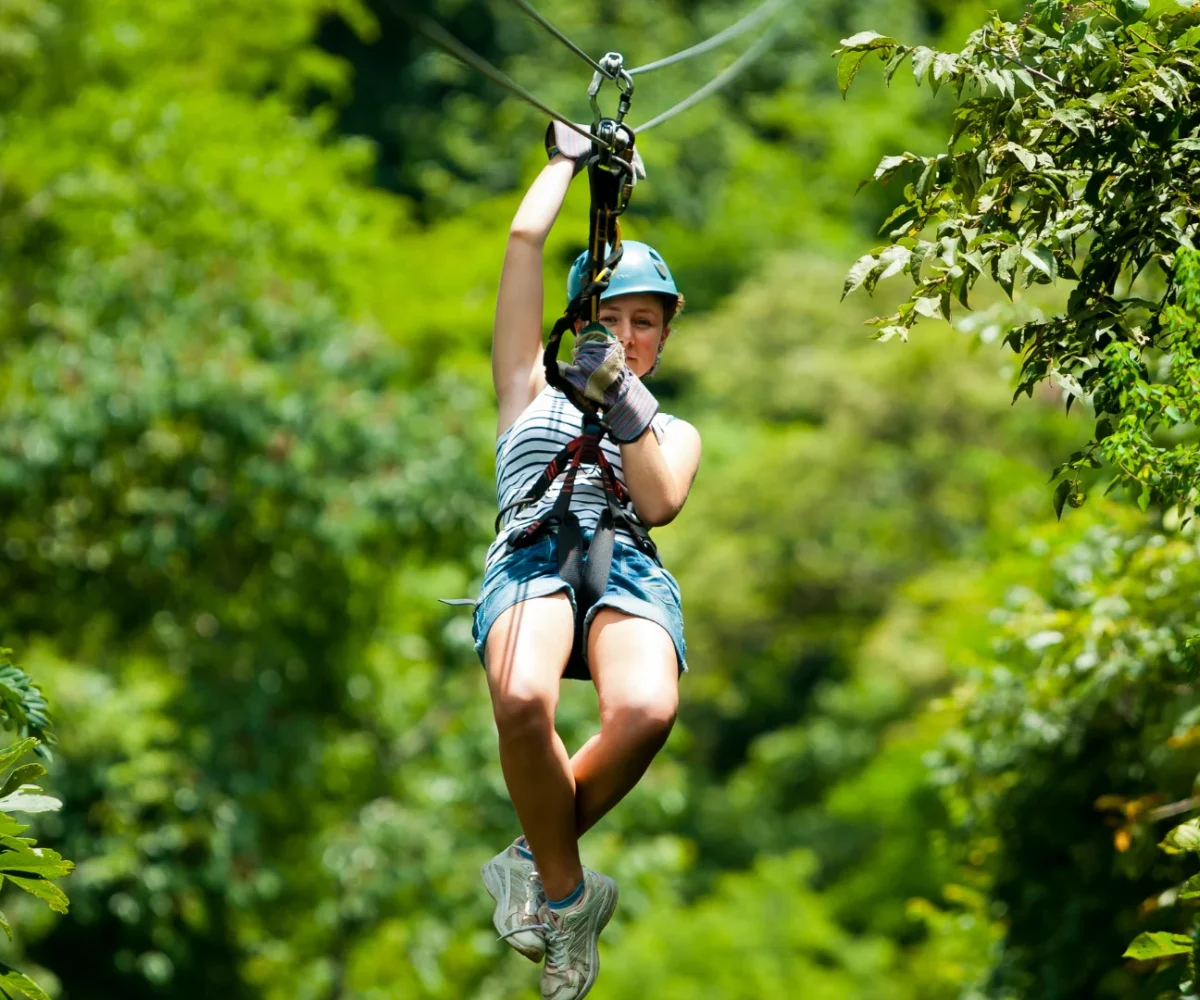 Zip line crossing the valley at Vallée des Couleurs Nature Park