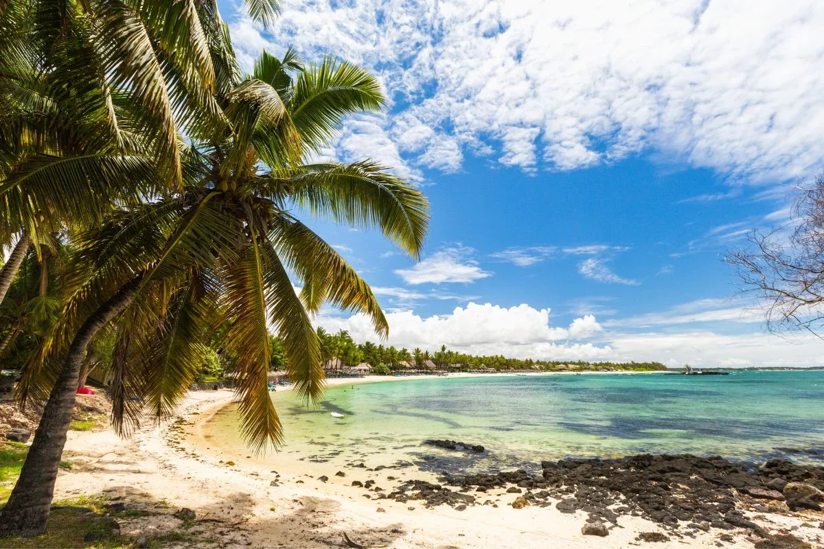 The long white sand and turquoise lagoon of Belle Mare beach on the east coast of Mauritius