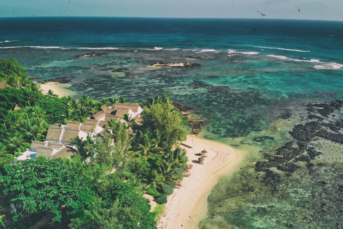 The quiet casuarina-backed shoreline at Bras d'Eau on the north-east coast of Mauritius