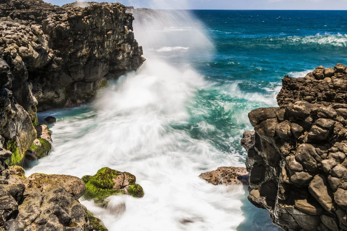 Waves bursting through the blowhole at Le Souffleur on the south coast of Mauritius