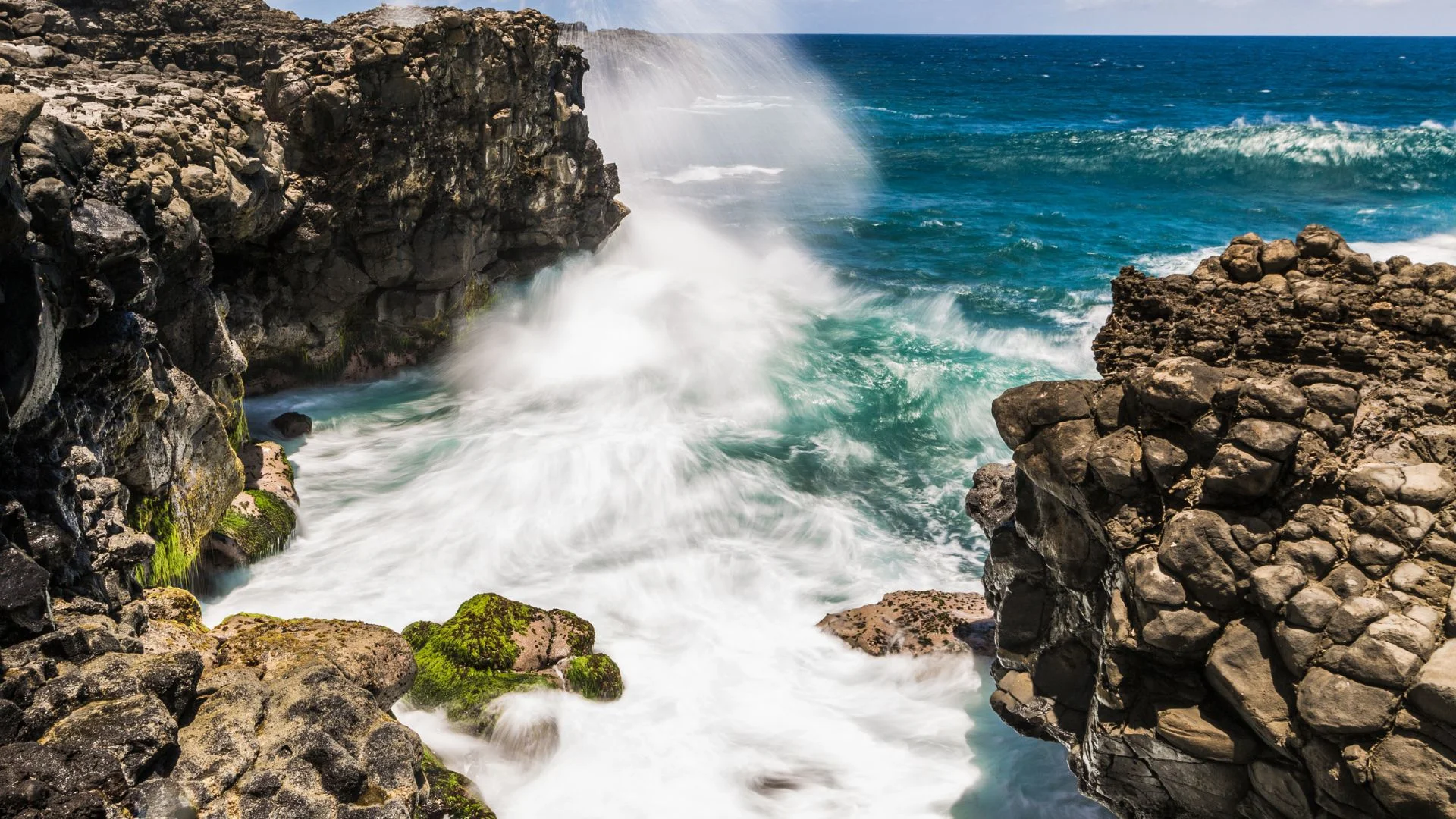 Waves bursting through the blowhole at Le Souffleur on the south coast of Mauritius