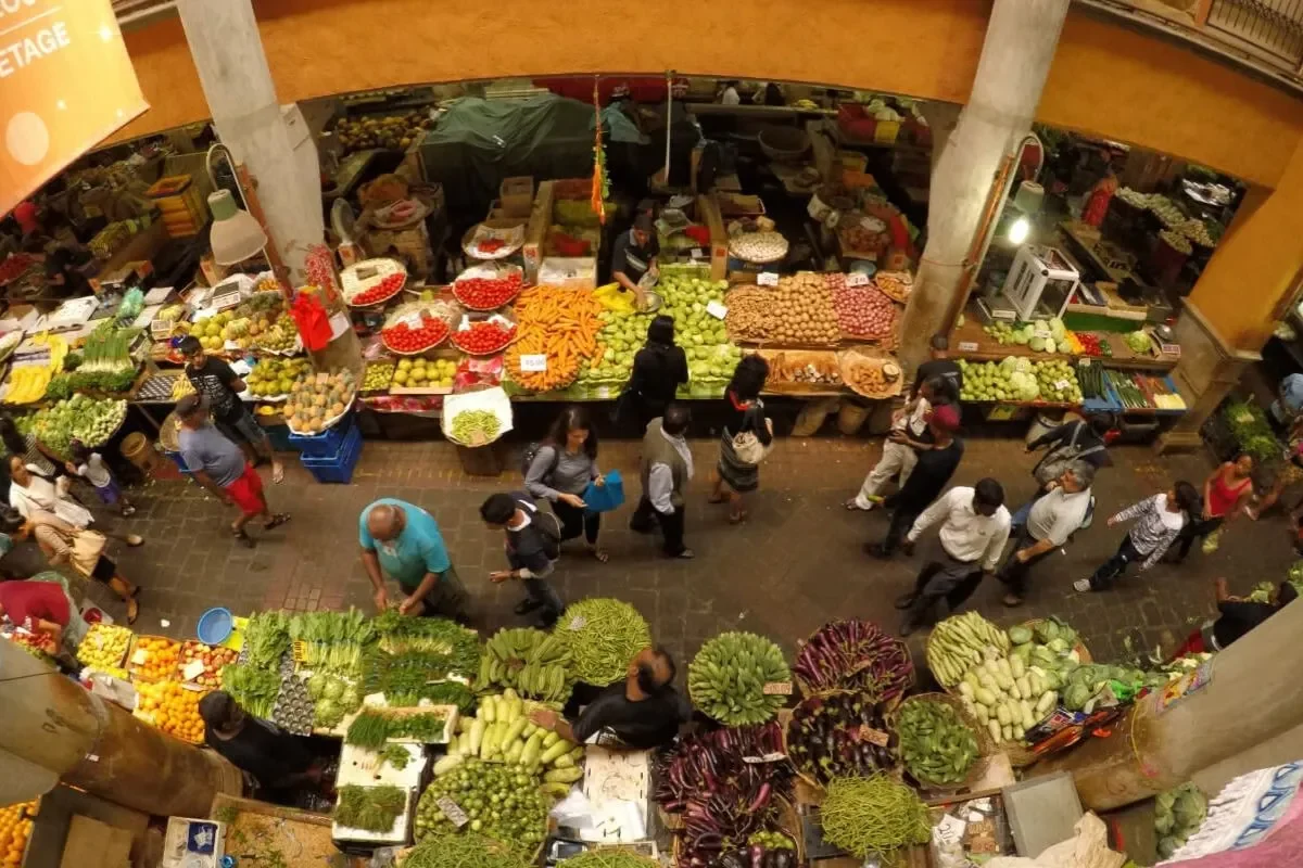 Stalls and produce under the iron roof of the Port Louis central market